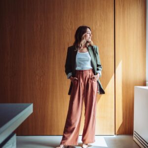 Confident Businesswoman Posing in Modern Office Wearing Trendy Outfit